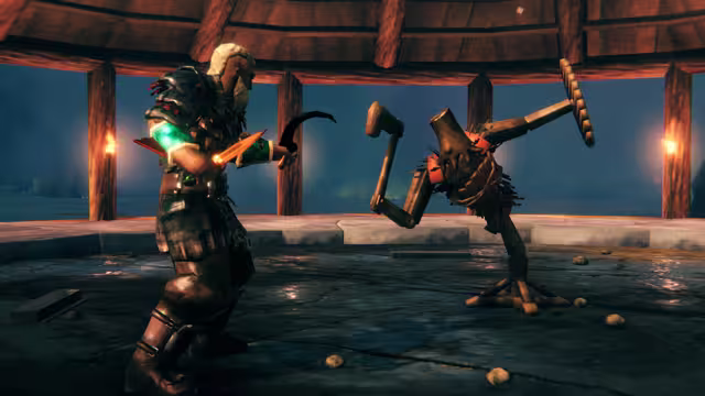 Screenshot of an armored Viking holding a curved knife facing a wooden training dummy with a mallet arm inside a round wooden hall lit by wall torches.