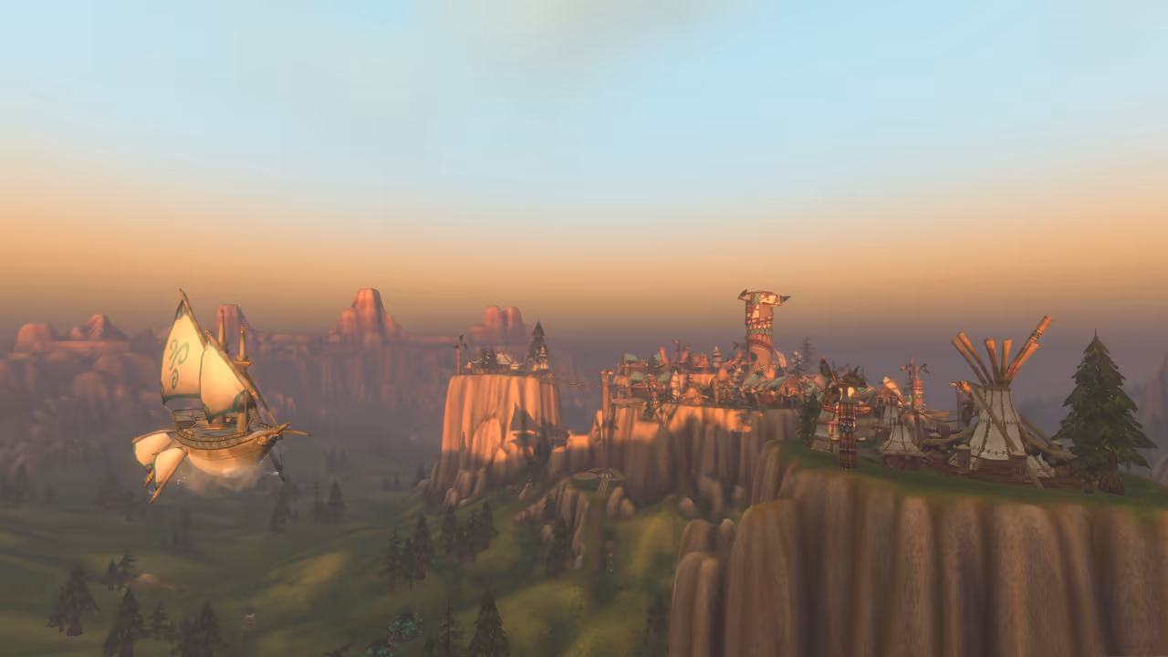 A wooden ship with cream sails marked with green swirls hangs in the air over a grassy valley with pines. To the right, tall flat-topped cliffs joined by rope bridges carry a crowded town of painted buildings, hide tents and a carved totem tower, with red mesas fading into a hazy golden sky.