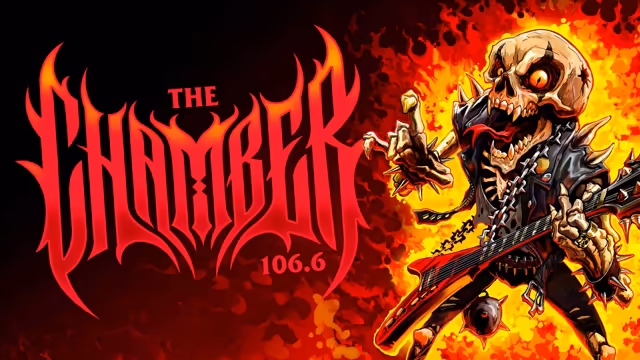On a background shading from black to fiery orange, flame-shaped red gothic letters spell The Chamber, with 106.6 below. At right, a cartoon skeleton with a glowing eye and a long tongue, in a studded leather vest hung with chains, throws a horns sign and holds a spiked red electric guitar.