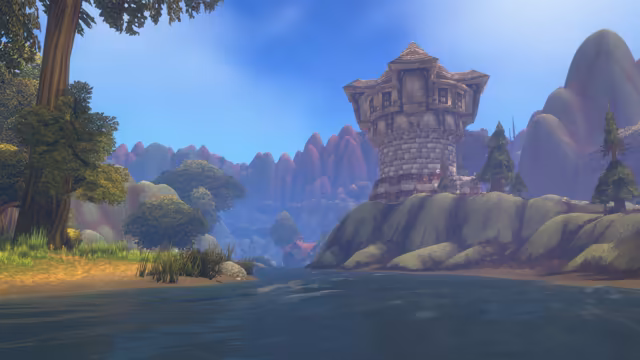 Seen from the water, a round stone tower with a wooden upper storey and a red band stands on a rocky outcrop beside a river. Tall trees and reeds line the sandy left bank, and the river leads back to a red-roofed building with a waterwheel beneath rounded purple-tinted hills under a blue sky.