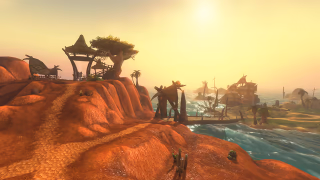 A cracked red earth path runs along a headland toward a thatched shelter raised on wooden poles, a leafy tree and a hide-covered tent. Below, a wooden pier lined with pale tusks and a carved arch reaches over bright turquoise water toward several sailing ships and palm-covered islets in a hazy golden light.