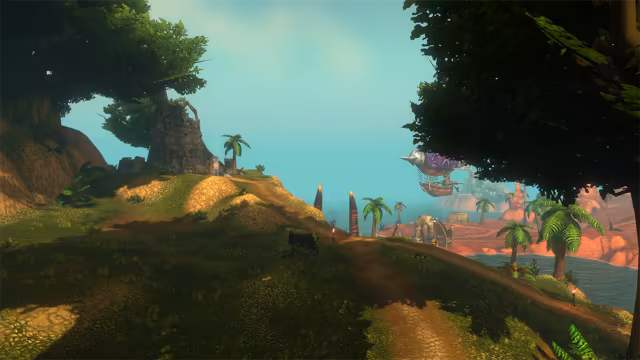 Framed by dark tree canopies, a sunlit dirt path crosses a grassy hill marked with small torches and two red-banded posts. A broken stone tower stands under a large tree on the left, and on the right, beyond palms, a spiked airship with a purple balloon floats over a red rock shore with carved ruins and a channel of water.