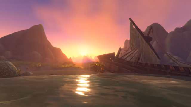 A low sun lights a pink and orange sky between rocky hills and glints on shallow water. A broken wooden ship with a torn sail lies tilted on the sand at the right, and thatched huts on wooden stilts with torches stand along the shore, with small green creatures among them and a crab on the sand.